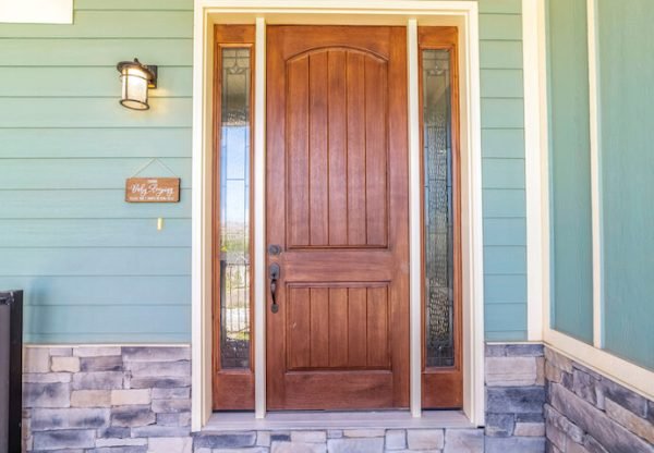wood entry door on green house